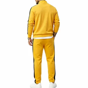 Back view of men's yellow tracksuit with black side stripes on white background