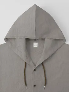 Close-up detail of grey hooded cotton shirt showing fabric texture and neck drawstring