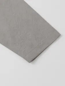 Close-up view of gray cotton linen fabric texture and sleeve cuff stitching detail