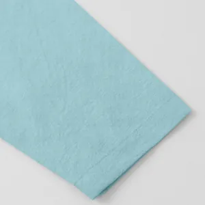 Detailed texture of light blue cotton linen men's casual shirt with hem stitching