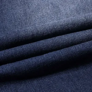 Macro view showing the detailed texture and wash of blue stretch denim fabric