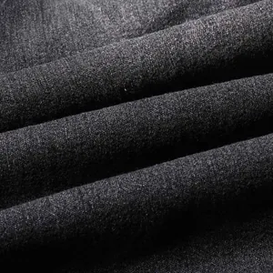 Close-up macro shot of dark grey vintage denim fabric texture with diagonal weave