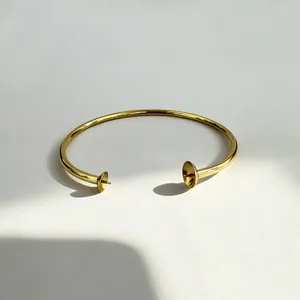 Detailed view of 18K gold plated stainless steel cuff bracelet with pearl settings