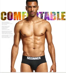 Male model wearing SEEINNER low-waist black cotton briefs with brand logo waistband
