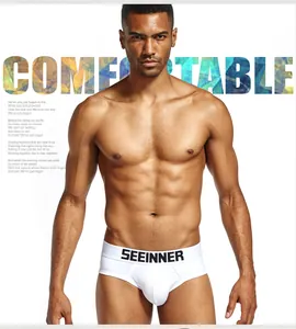 Close-up detail of men's white combed cotton briefs with a U-shaped pouch shown on model