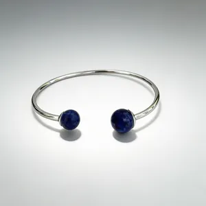 Close-up of silver stainless steel bangle with two blue lapis lazuli gemstone spheres