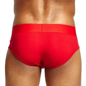 Comfortable red men's briefs made of combed cotton with a low waist and push-up fit.