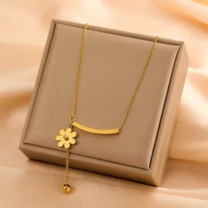 Close-up of elegant 18k gold plated titanium steel necklace with flower pendant detail