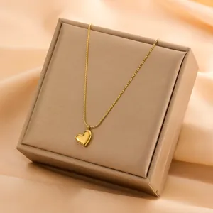 Close-up of minimalist 18k gold plated heart pendant necklace on display box