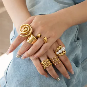 Detailed close-up of oversized gold stainless steel geometric rings with pearl accents