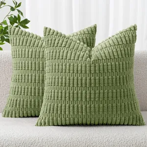 Macro view of green corduroy striped pillow covers with soft wheat-ear textured fabric