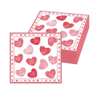 Close-up detail of pink heart-patterned Valentine's napkins with romantic phrases