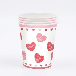 Detail of Valentine's Day pink heart disposable paper cups for party table decoration.