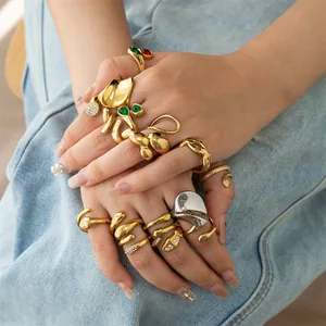 Macro view of gold and silver chunky stainless steel rings on denim background