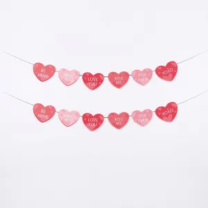 Close-up detail of a pink and red paper heart banner for Valentine's Day party decorations
