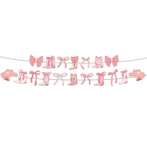 Pink cowboy themed party garland decoration featuring cute boots, hats, and bows details