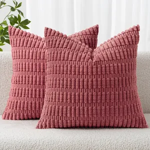 Close-up macro view of dusty rose corduroy cushion covers with textured wheat ear stripes