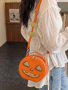 Detail shot of an orange pumpkin crossbody bag with glitter jack-o-lantern face