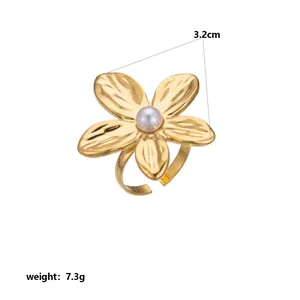 Close-up of golden flower ring with pearl center, 3.2cm diameter and 7.3g weight