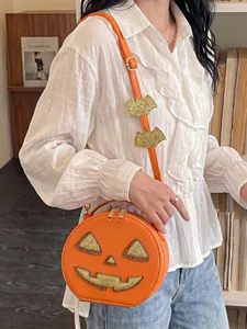 Detailed view of a quirky orange pumpkin crossbody bag with bat wing strap for Halloween