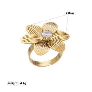 Detailed close-up view of a gold stainless steel flower ring featuring a zircon centerpiece
