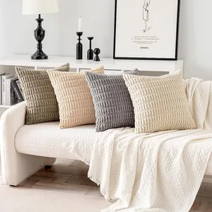 Detailed texture of wheat ear corduroy pillow covers in neutral tones on a white sofa