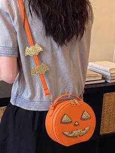 Detailed view of a creative orange pumpkin-shaped shoulder bag with glittery bat decor for Halloween