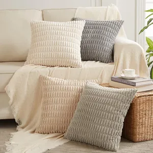 Cozy corduroy striped pillow covers with textured wheat ear pattern on sofa.