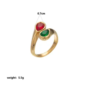 Detailed view of a gold-plated stainless steel ring featuring red and green teardrop stones.