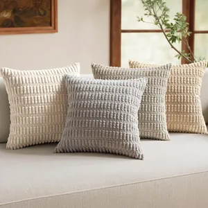 Set of wheat-spike ribbed corduroy cushion covers in neutral tones on a light sofa