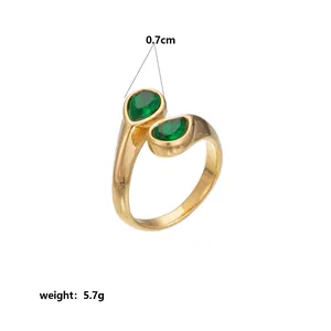 Close-up detail of a gold ring with green pear-shaped stones and weight specification