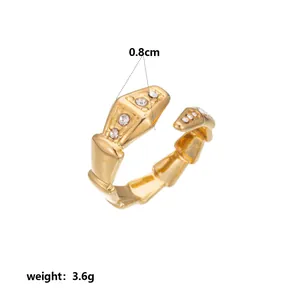 Detail view of gold geometric ring with 0.8cm width and stone inlays