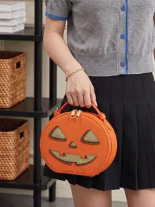 Detailed view of the Halloween pumpkin shaped handbag with a cute glittery face design