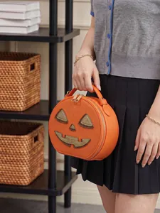 Close-up of a creative Jack-o'-lantern shaped pumpkin crossbody bag for Halloween