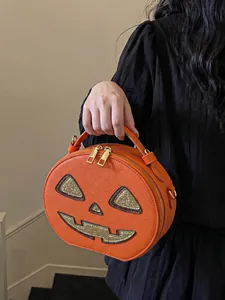 Detailed close-up of a quirky orange pumpkin-shaped handbag for Halloween outfits