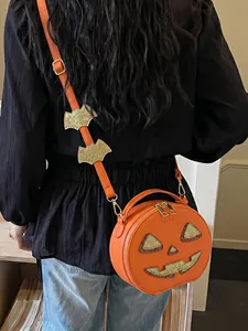 Back view of a model wearing a stylish orange pumpkin-shaped crossbody bag with glitter details.
