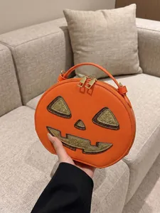 Close-up of a creative and vibrant orange pumpkin-shaped handbag for Halloween party