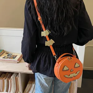 Creative Halloween pumpkin shaped crossbody bag featuring glitter bat charms on strap