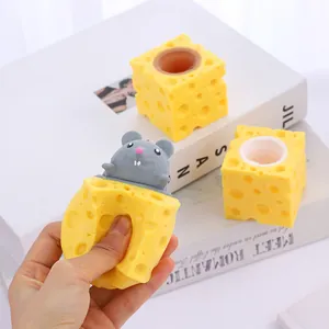 Detailed macro view showing the texture of the TPR cheese and mouse squeeze toy being pressed