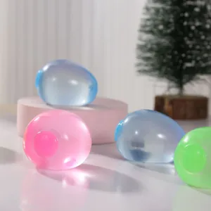 Close-up of colorful translucent egg-shaped stress relief squeeze toys on a white surface.
