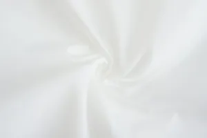 Close-up of premium breathable white fabric texture with elegant swirl pattern for jacket