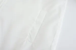 Detailed view of the functional side pocket on a white breathable sports jacket