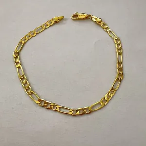 Detailed view of elegant 14K gold plated Figaro chain bracelet with secure lobster clasp