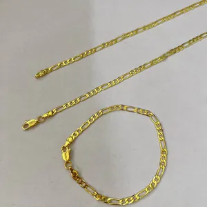 High-quality close-up of gold-plated Figaro chain jewelry featuring 14K stamp on the clasp.