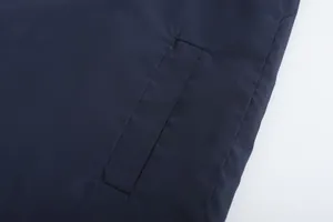 Close-up macro view of the pocket and fabric on a navy blue breathable sport jacket