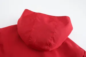 Close-up of red hood detail on a men's lightweight sportswear jacket