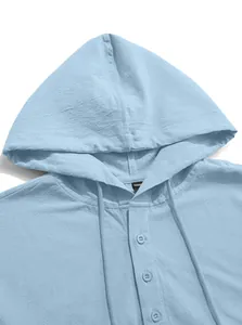 Detail view of light blue cotton linen hooded shirt with buttons and drawstrings