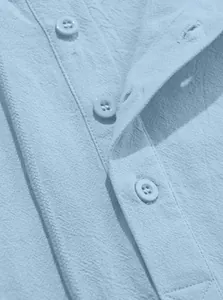 Macro view of light blue cotton linen fabric texture and buttons on a men's hooded shirt