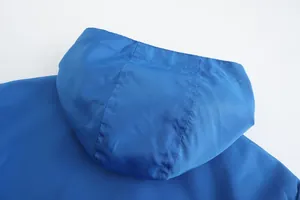Detailed close-up of a blue breathable sport jacket hood with clean stitching