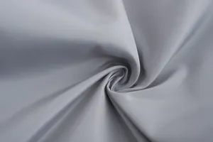 Detailed macro view of breathable grey fabric texture for men's lightweight sports jacket